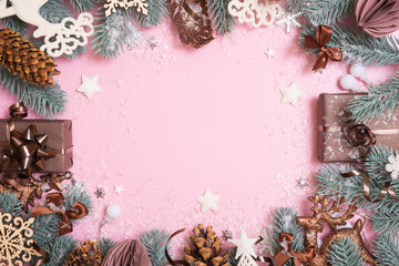 Wall Mural - New Year Xmas greeting card. Frame made frome pine tree branches and Christmas decoration on colored background
