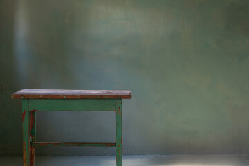 Wall Mural - old wooden table on background green old wall