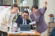 © PHAISITSAWAN - Team of Asian businessmen helping to brainstorm management ideas for the company are expressing joy and happiness that the company has achieved commercial success.