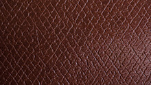 Close-up Genuine Leather Texture, Square Checkered. Reddish Brown Color, Natural Wrinkled Texture Wallpaper Pattern. Leather Accessory Production Concept.