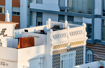 Wall Mural - The terrace lined with balustrades are linked together by small stairs in the Cubist architecture in Olhao, Algarve, Portugal	
