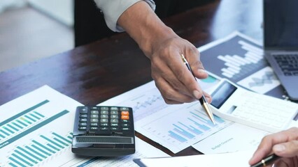 Wall Mural - Business team reviewing a diagram or chart and financial reports for a return on investment or investment risk analysis or business performance.