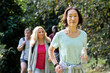 © PhotoAlto - Senior Asian-American woman hiking in mountain trail with group of friends