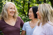 © PhotoAlto - Small group of middle-aged women chatting outdoors
