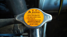 Car Radiator Cap With Warning In Many Language, In English Means Translate "never Open When Hot".