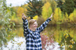 © Designpics - A young man with Down Syndrome raising his hands in worship to God, while in a city park on a warm fall evening; Edmonton, Alberta, Canada