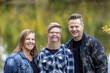 © Designpics - A young man with Down Syndrome posing for a family portrait with his father and mother while enjoying each other's company in a city park on a warm fall evening; Edmonton, Alberta, Canada