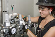 © Designpics - Female trades worker installing a fuel gas regulator; Innisfail, Alberta, Canada