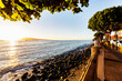 © Designpics - Shops along the coast and the sun setting over the coastline in Lahaina; Lahaina, Maui, Hawaii, United States of America