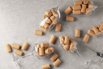 Canvas Print - Glasses with wine corks and corkscrew on light table, flat lay