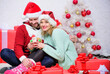 © be free - Love is best gift. Couple in love enjoy christmas holiday celebration. Loving woman and bearded man wear santa claus hat christmas tree background. Christmas eve with darling. Begin new year together