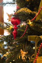 Close Up Of Christmas Tree With Red And Gold Decorations