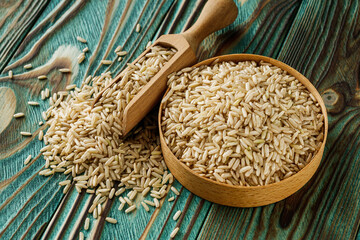 Wall Mural - raw unpolished rice on a wooden rustic background