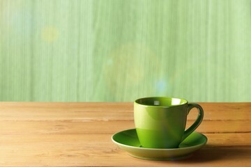 Canvas Print - Green classic ceramic mug on table