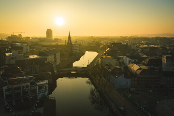 Wall Mural - Aerial view with industrial yellow foggy morning Cork Irealnd modern building 