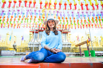 Poster - Asian female tourist with Lanna style background in Lamphun province