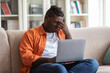 © Prostock-studio - Young upset black man using laptop at home