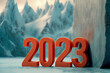 new year 2023 orange numbers on a breathtaking alpine mountain background