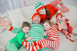 © kichigin19 - christmas pajama striped party family with kids, new year costumes, fun at home in bed
