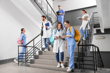 Canvas Print - Medical students wearing uniforms on staircase in college