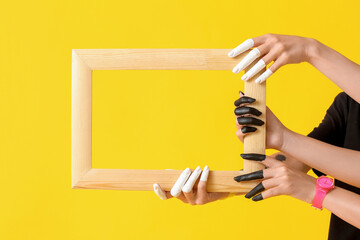 Poster - Female hands with wooden frame on color background