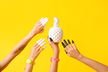 Wall Mural - Female hands with hand watches, painted fingers and white pineapple on color background