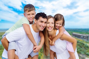 Wall Mural - Parents with happy child walking outdoor