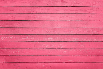 Trendy color of the year 2023. Wooden planks boards, gorizontal pattern, toned in viva magenta color as background or texture