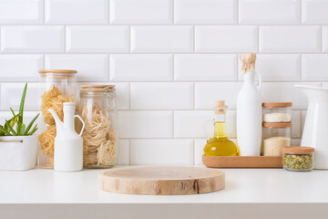 Wall Mural - wooden pedestal on table in kitchen interior with food ingredients