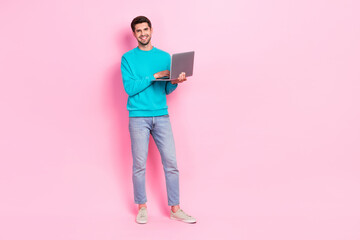 Aufkleber - Full length photo of handsome young guy hold laptop digital nomad working remotely wear trendy blue look isolated on pink color background