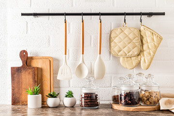 Wall Mural - beautiful storage area on a modern kitchen countertop. various glass jars with bulk products. wooden boards. kitchen holder, railing