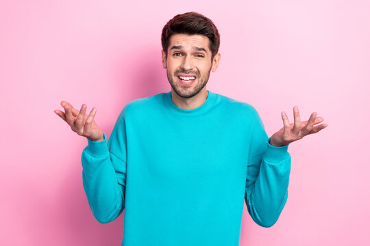 Photo portrait of nice young guy shrug shoulders confused shocked wear trendy blue garment isolated on pink color background