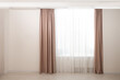 Elegant window curtains and white tulle indoors. Interior design