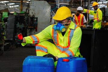 worker wearing uniform protection chemicals.Industrial worker holding plastic bottle with chemicals in factory.