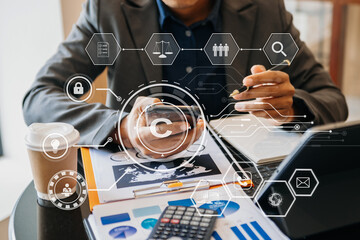Wall Mural - Copyright or patent concept, Business team analyzing data and using smart phone and tablet with virtual screen copyright icon trademark license, Creation ownership against piracy.