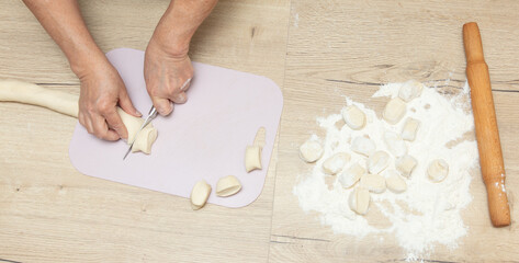 Sticker - Cutting dough with a knife.