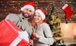 © be free - Happy family. Man and woman santa hats thankful for received gift. Boxing day. Couple in love new years eve. Pleasant surprise. Family celebrating xmas at home. Family respect christmas traditions