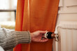 © Johnér - Woman turning radiator thermostat