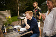 © Johnér - Happy friends having meal in garden