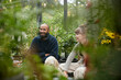 © Johnér - Smiling friends sitting in greenhouse