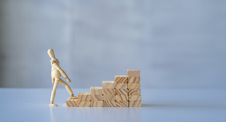 wooden man walking up the career ladder Wooden brick ladder, concept of self-improvement, career, transformation, success step. White background. copy space for ads