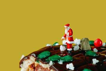 Wall Mural - miniature santa claus on a yule log cake