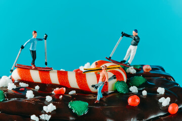 Wall Mural - miniature skiers on a yule log cake