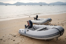 Two Inflatable Rubber Boats With A Motor On The Beach To Deliver Provisions To Yachts At Sea.