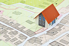 New Home And Free Vacant Land For Building Activity - Construction Industry Concept With A Residential Building, Imaginary Cadastral Map, General Urban Planning And Zoning Regulations