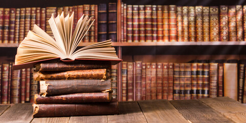 Wall Mural - Composition with vintage old hardback books, diary, fanned pages on wooden deck table and red background. Books stacking. Back to school. Copy Space. Education background.	