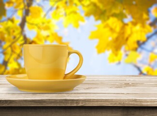 Sticker - Ceramic cup of hot drink on autumn background