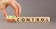 © Dzmitry - In or out of control symbol. Concept words In control and Out of control on wooden cubes. Businessman hand. Beautiful grey table grey background. Business in or out of control concept. Copy space.