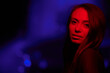 © ADDICTIVE STOCK - Young woman under red neon light