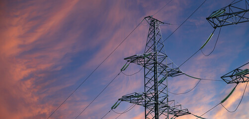 Wall Mural - Electricity pylon (high voltage power line) against the background of a romantic evening sky